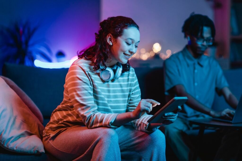 Smiley woman home using headphones and tablet with high-speed internet